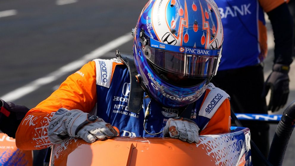Scott Dixon, of New Zealand, climbs out od his car during practice for the Indianapolis 500 auto race at Indianapolis Motor Speedway, Friday, May 20, 2022, in Indianapolis. (AP Photo/Darron Cummings)