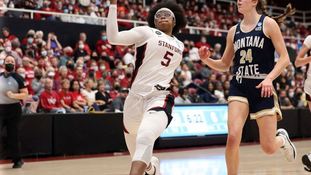 Stanford's Fran Belibi prepares to dunk against Montana State's Taylor Janssen during the second quarter of an NCAA women's college basketball tournament first-round game, March 18, 2022, in Stanford, Calif. Belibi joined an exclusive club when she d