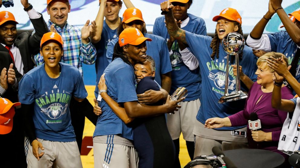 FILE - Minnesota Lynx center Sylvia Fowles hugs WNBA president Lisa Borders after receiving the MVP trophy as the Lynx celebrate their WNBA championship, Wednesday, Oct. 4, 2017 in Minneapolis. Fowles, one of the league's greatest centers, is ready t