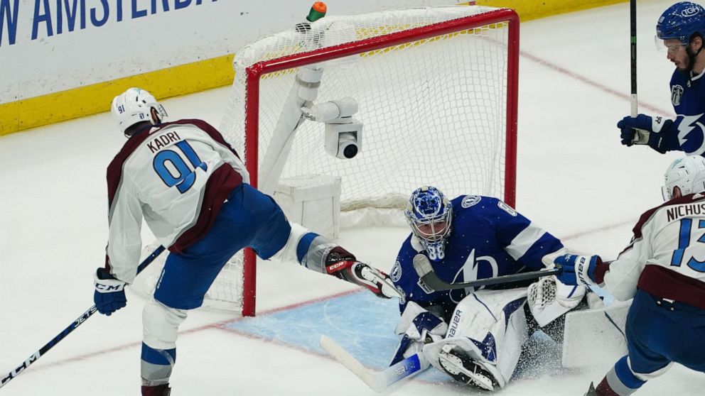 Colorado Avalanche center Nazem Kadri shoots the puck into the top of the goal past Tampa Bay Lightning goaltender Andrei Vasilevskiy (88) for a goal during overtime of Game 4 of the NHL hockey Stanley Cup Finals on Wednesday, June 22, 2022, in Tampa