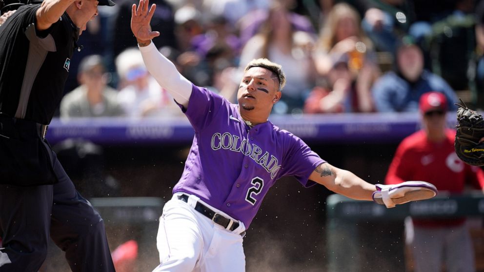 Colorado Rockies' Yonathan Daza reacts after scoring on a double by Brendan Rodgers in the second inning of a baseball game against the Cincinnati Reds, Sunday, May 1, 2022, in Denver. (AP Photo/David Zalubowski)