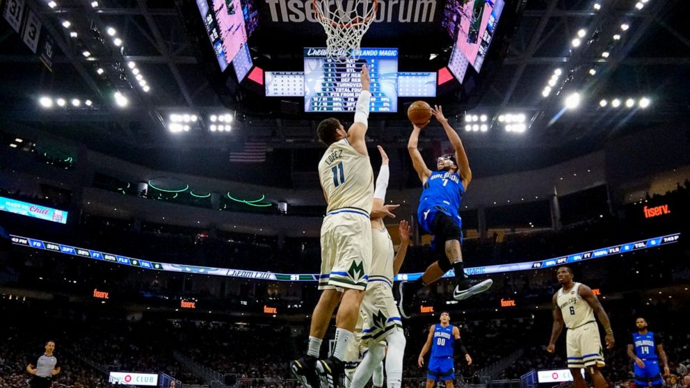Orlando Magic's Michael Carter-Williams shoots past Milwaukee Bucks' Brook Lopez during the first half of an NBA basketball game Monday, Dec. 9, 2019, in Milwaukee. (AP Photo/Morry Gash)