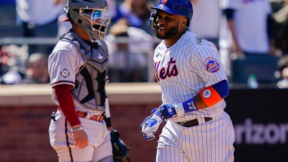 New York Mets' Robinson Cano celebrates after hitting a solo home run off Arizona Diamondbacks starting pitcher Zach Davies in the fourth inning of a baseball game, Friday, April 15, 2022, in New York. (AP Photo/John Minchillo)