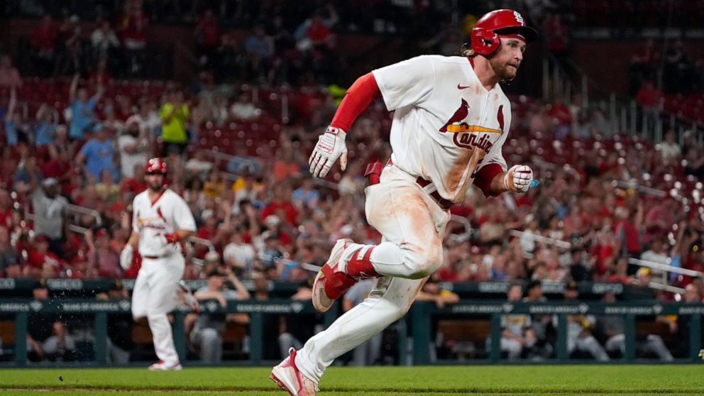 St. Louis Cardinals' Brendan Donovan, right, rounds first on his way to a two-run double as Paul Goldschmidt, left, comes in to score during the sixth inning of a baseball game against the Pittsburgh Pirates Monday, June 13, 2022, in St. Louis. (AP P