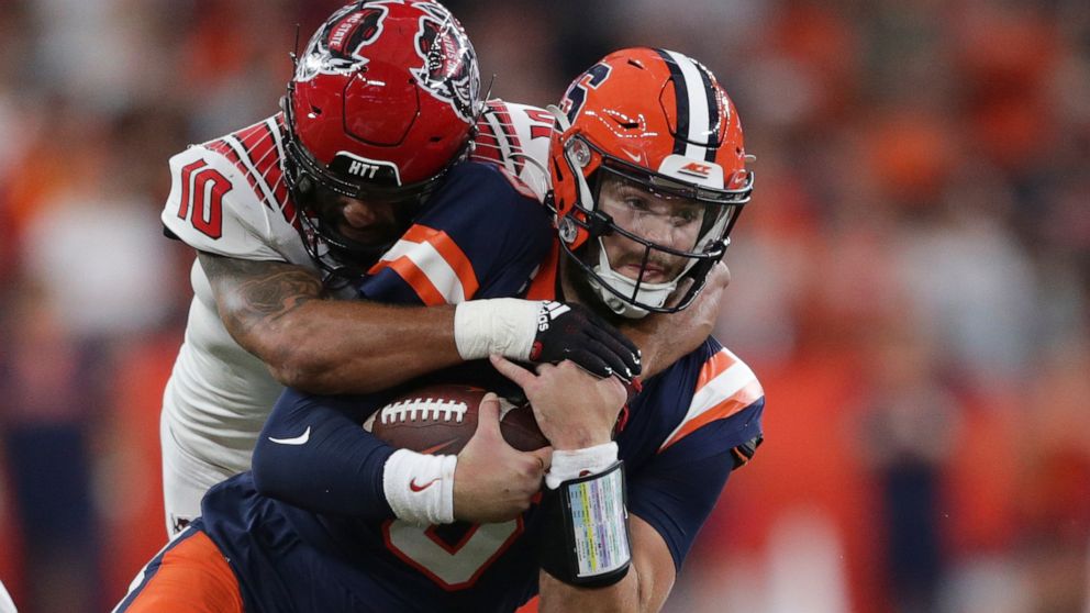North Carolina State safety Tanner Ingle (10) tackles Syracuse quarterback Garrett Shrader, right, during the second half of an NCAA college football game Saturday, Oct. 15, 2022, in Syracuse, N.Y. (AP Photo/Joshua Bessex)