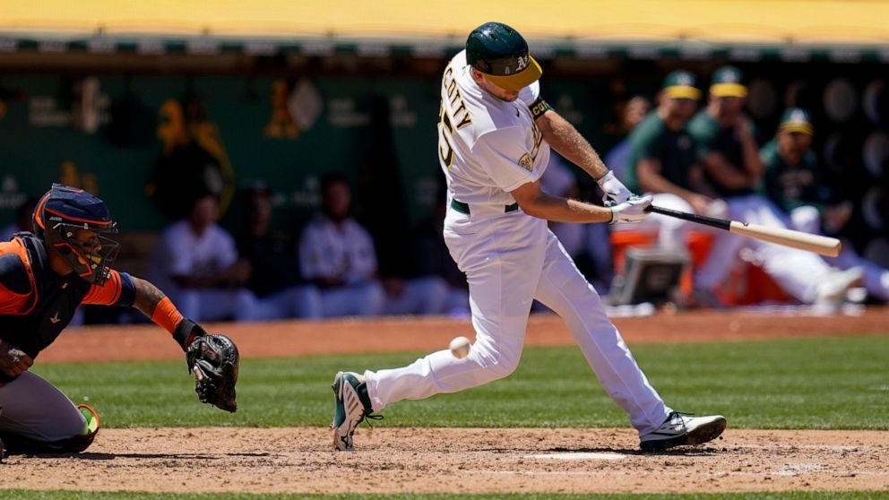 Oakland Athletics' Stephen Piscotty, right, strikes out against the Houston Astros to end the sixth inning of a baseball game in Oakland, Calif., Saturday, July 9, 2022. (AP Photo/Godofredo A. Vásquez)