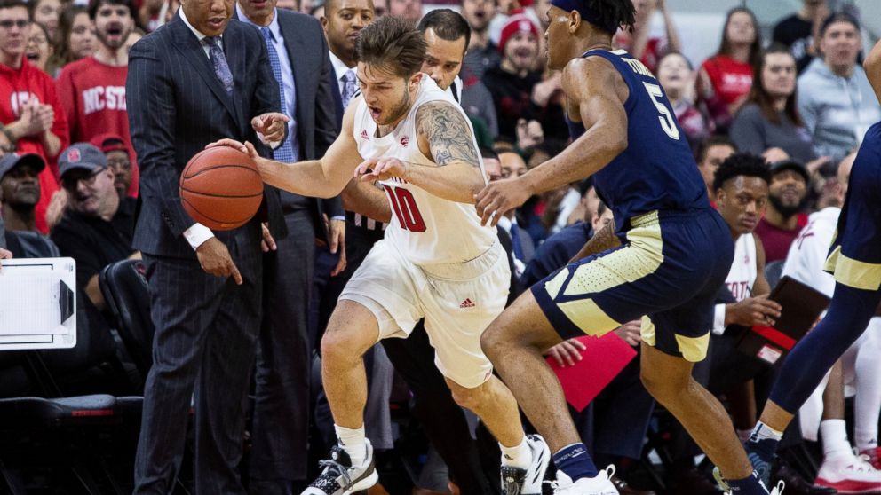 North Carolina State's Braxton Beverly (10) handles the ball in front of North Carolina State coach Kevin Keatts, left, as Pittsburgh's Au'Diese Toney (5) defends during the first half of an NCAA college basketball game in Raleigh, N.C., Saturday, Ja