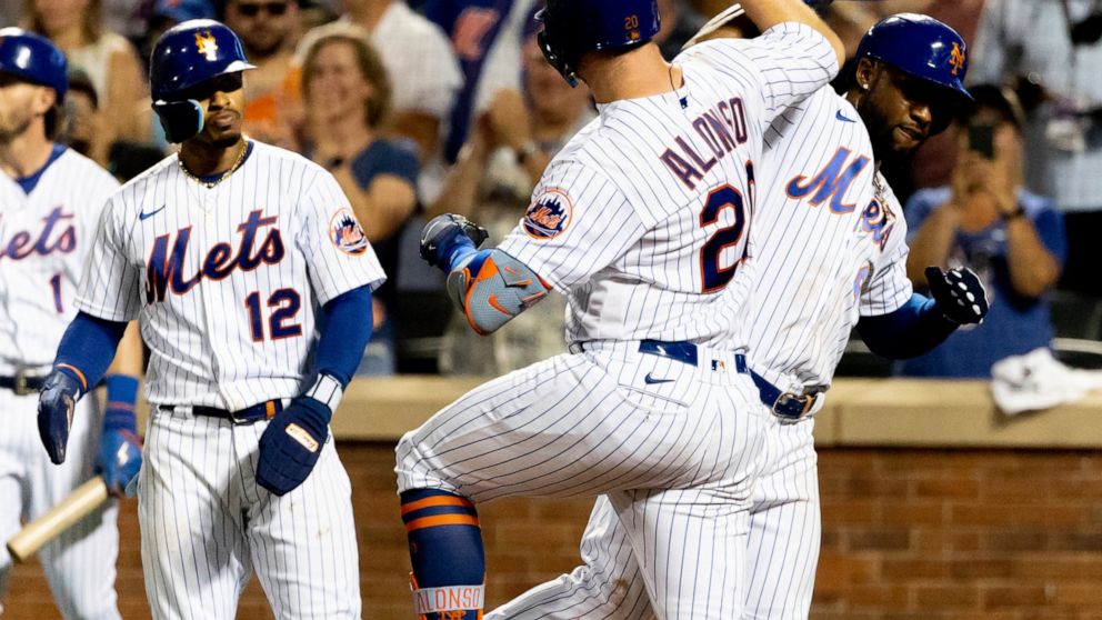 New York Mets' Francisco Lindor, Pete Alonso and Starling Marte celebrate after scoring three runs during the sixth inning of a baseball game against the San Diego Padres, Sunday, July 24, 2022, in New York. (AP Photo/Julia Nikhinson)
