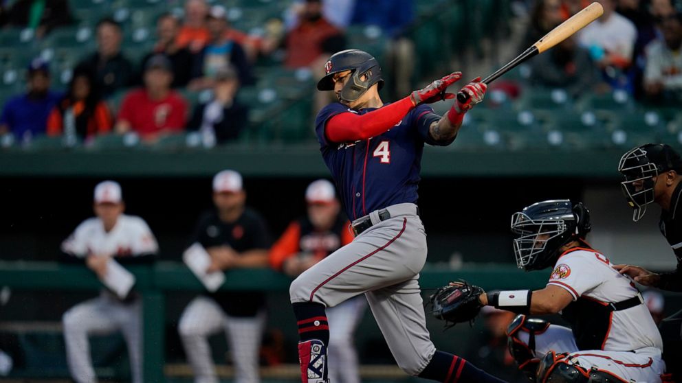 Minnesota Twins' Carlos Correa follows through on a swing against the Baltimore Orioles during the first inning of a baseball game, Thursday, May 5, 2022, in Baltimore. (AP Photo/Julio Cortez)