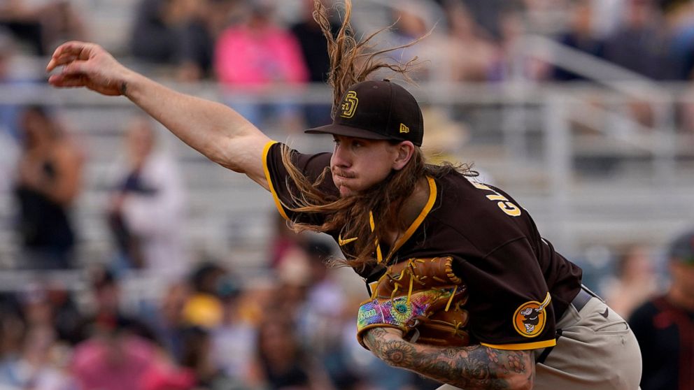 San Diego Padres starting pitcher Mike Clevinger throws against the San Francisco Giants during the second inning of a spring training baseball game, Tuesday, March 29, 2022, in Scottsdale, Ariz. Clevinger's long wait will last one more day. The righ