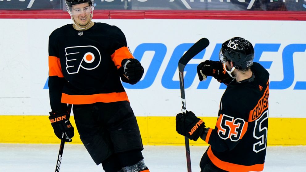 Philadelphia Flyers' Robert Hagg, left, and Shayne Gostisbehere celebrate after Hagg's goal during the third period of an NHL hockey game against the Pittsburgh Penguins, Monday, May 3, 2021, in Philadelphia. (AP Photo/Matt Slocum)