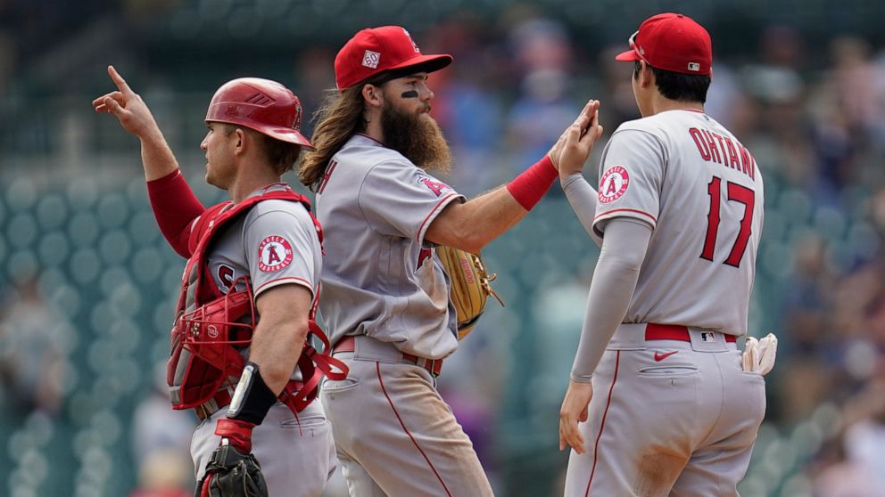 Los Angeles Angels catcher Max Stassi, from left, Brandon Marsh and Shohei Ohtani (17) celebrate after beating the Detroit Tigers 13-10 in a baseball game in Detroit, Thursday, Aug. 19, 2021. (AP Photo/Paul Sancya)