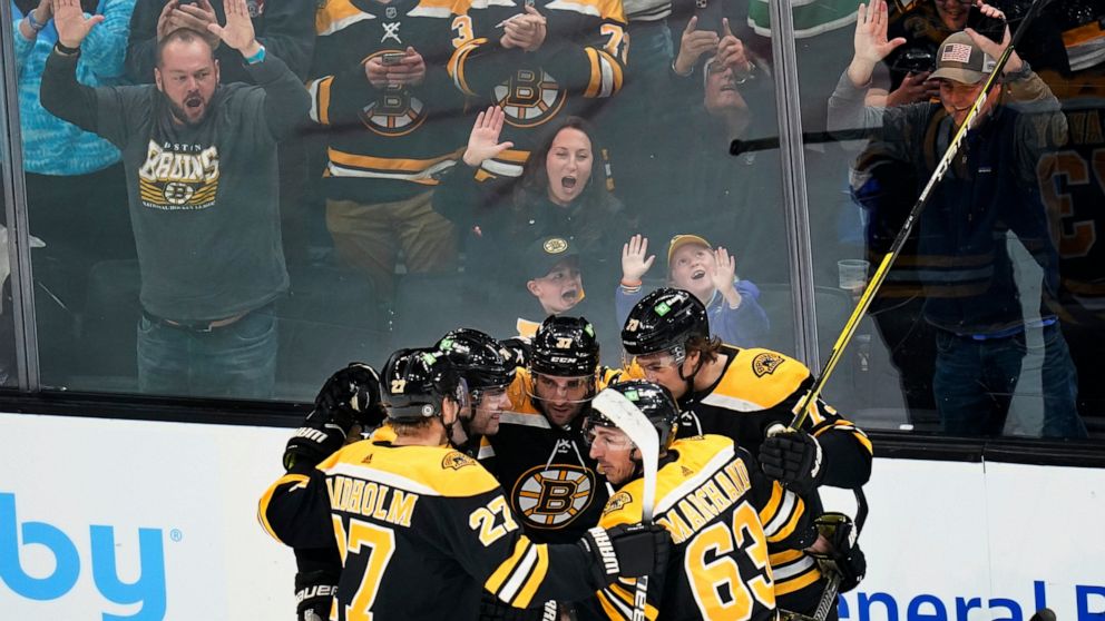 Boston Bruins and fans celebrate a goal by Patrice Bergeron (37) during the second period of the team's NHL hockey game against the Buffalo Sabres, Thursday, April 28, 2022, in Boston. (AP Photo/Charles Krupa)
