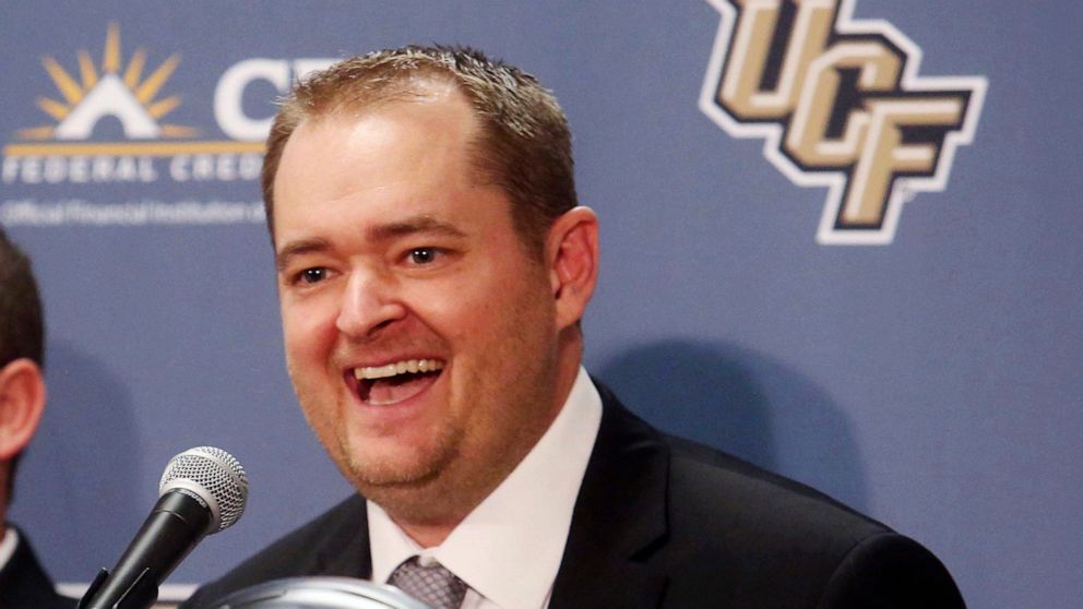FILE - In this Dec. 5, 2017, file photo, Josh Heupel smiles as he is introduced as the new Central Florida head football coach during an NCAA college football news conference in Orlando, Fla. Heupel, who was the Heisman Trophy runner-up for Oklahoma 