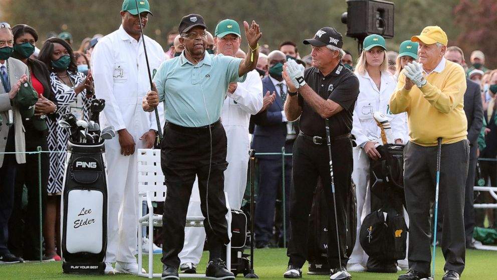 Honorary starter Lee Elder, left, gestures as he is introduced and applauded by honorary starters Gary Player and Jack Nicklaus, right, before the ceremonial tee shots to begin the Masters golf tournament at Augusta National Golf Club in Augusta, Ga.