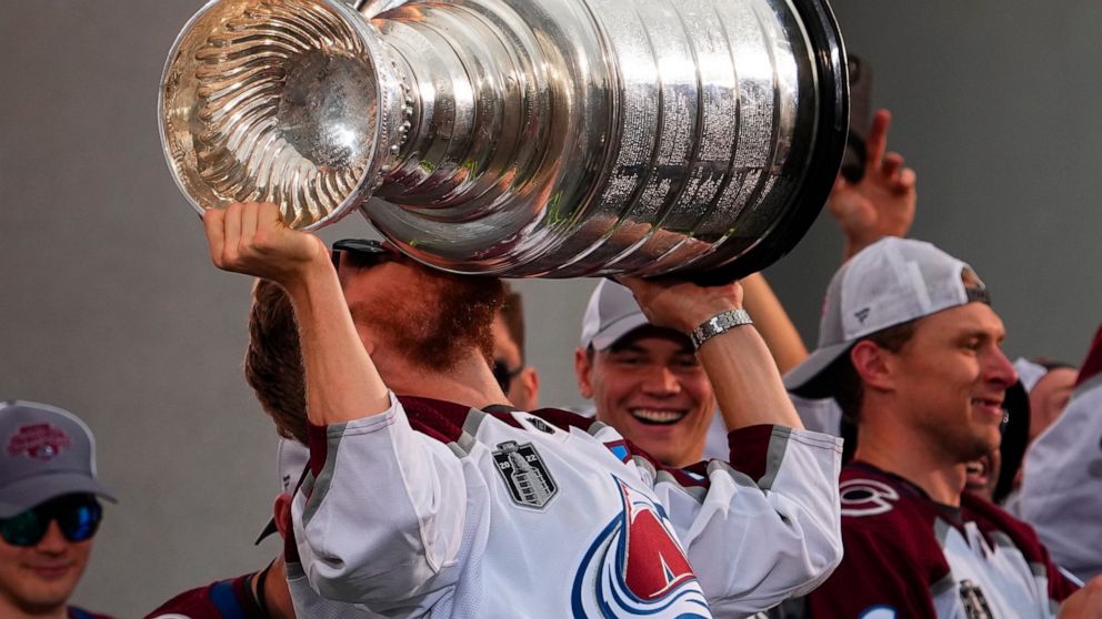 FILE - Colorado Avalanche left wing Gabriel Landeskog kisses the Stanley Cup at a rally for the NHL hockey champions Thursday, June 30, 2022, in Denver. All the Stanley Cup parties and parades are over for the Colorado Avalanche. The shorter-than-mos