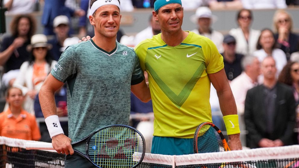 Norway's Casper Ruud, left, and Spain's Rafael Nadal pose at the net prior to the men's final match at the French Open tennis tournament in Roland Garros stadium in Paris, France, Sunday, June 5, 2022. (AP Photo/Michel Euler)