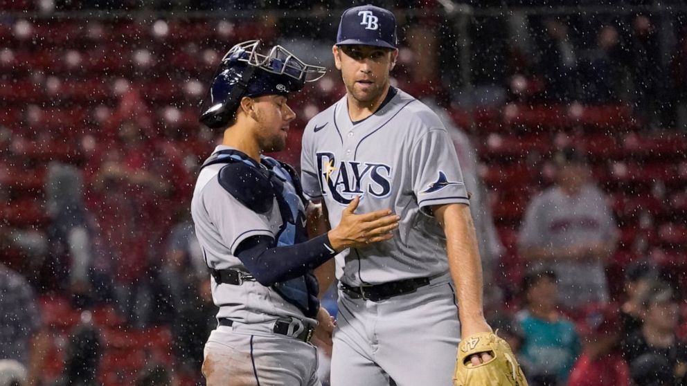 Tampa Bay Rays closer Jason Adam, right is congratulated by catcher Rene Pinto after the team's win over th Boston Red Sox in a baseball game at Fenway Park, Tuesday, July 5, 2022, in Boston. (AP Photo/Mary Schwalm)