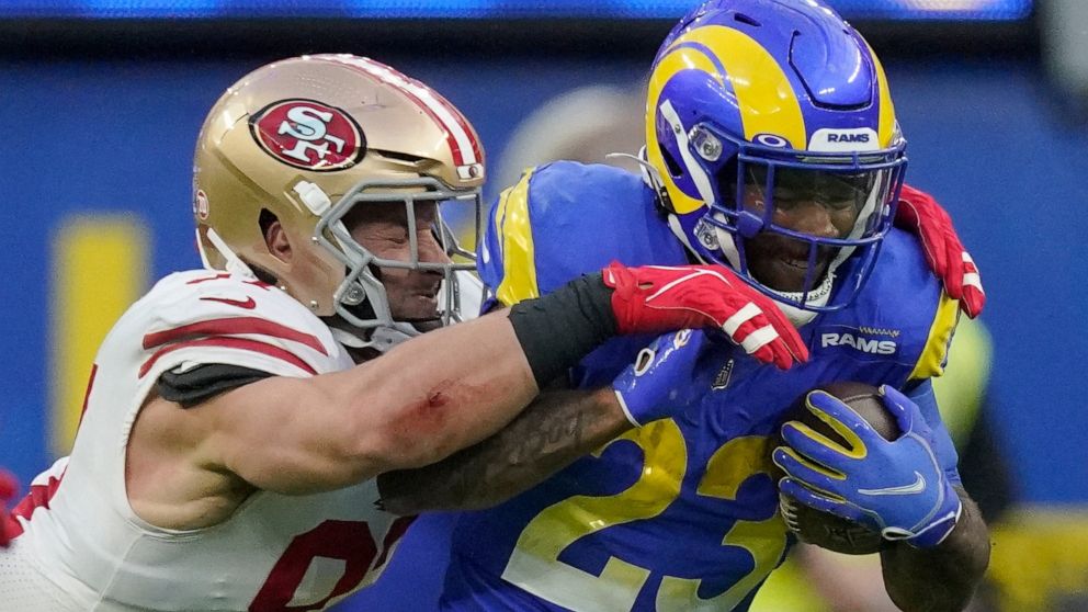 San Francisco 49ers' Nick Bosa, left, stops Los Angeles Rams' Cam Akers during the first half of the NFC Championship NFL football game Sunday, Jan. 30, 2022, in Inglewood, Calif. (AP Photo/Mark J. Terrill)