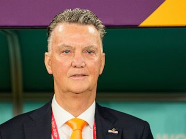 Netherlands coach Van Gaal hugs reporter at World Cup