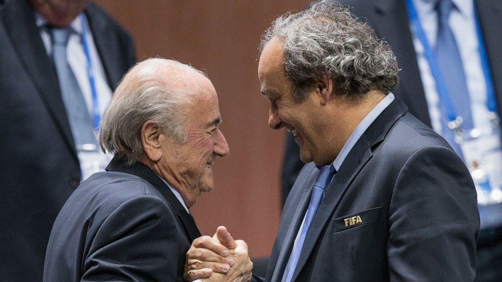FILE - FIFA president Sepp Blatter is greeted by UEFA President Michel Platini, right, after Blatter's re-election as president at the Hallenstadion in Zurich, Switzerland, on May 29, 2015. Sepp Blatter and Michel Platini enter a criminal court Wedne