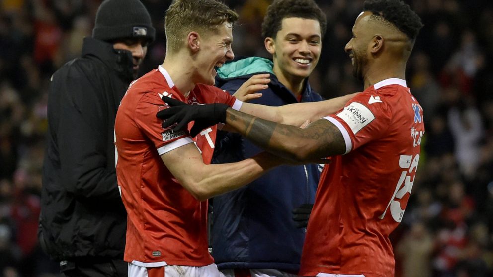 Nottingham Forest's Ryan Yates, Brennan Johnson and Cafu, from left, celebrate at the end of the English FA Cup fourth round soccer match between Nottingham Forest and Leicester City at the City Ground, Nottingham, England, Sunday, Feb. 6, 2022. Nott