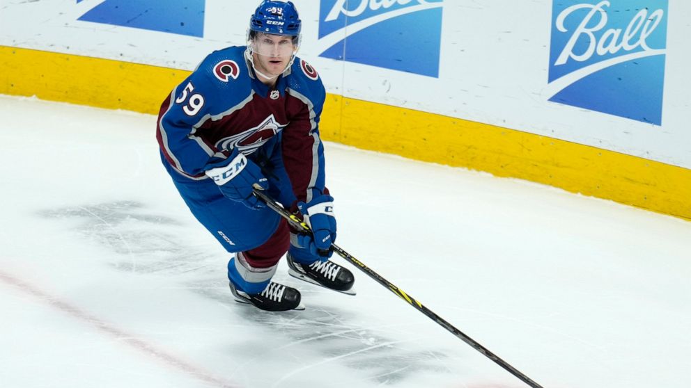 Colorado Avalanche center Ben Meyers (59) moves the puck in his first NHL game during the first period against the Carolina Hurricanes Saturday, April 16, 2022, in Denver. (AP Photo/Jack Dempsey)