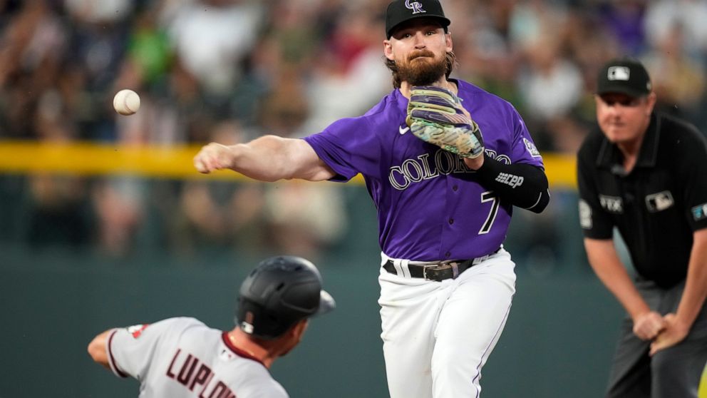 Colorado Rockies second baseman Brendan Rodgers throws over Arizona Diamondbacks' Jordan Luplow after forcing him out at second base on the front end of a double play hit into by Cooper Hummel during the sixth inning of a baseball game Saturday, July