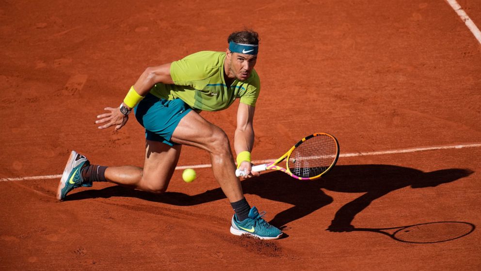 Spain's Rafael Nadal returns the ball to Netherlands' Botic van de Zandschulp during their third round match of the French Open tennis tournament at the Roland Garros stadium Friday, May 27, 2022 in Paris. (AP Photo/Christophe Ena)