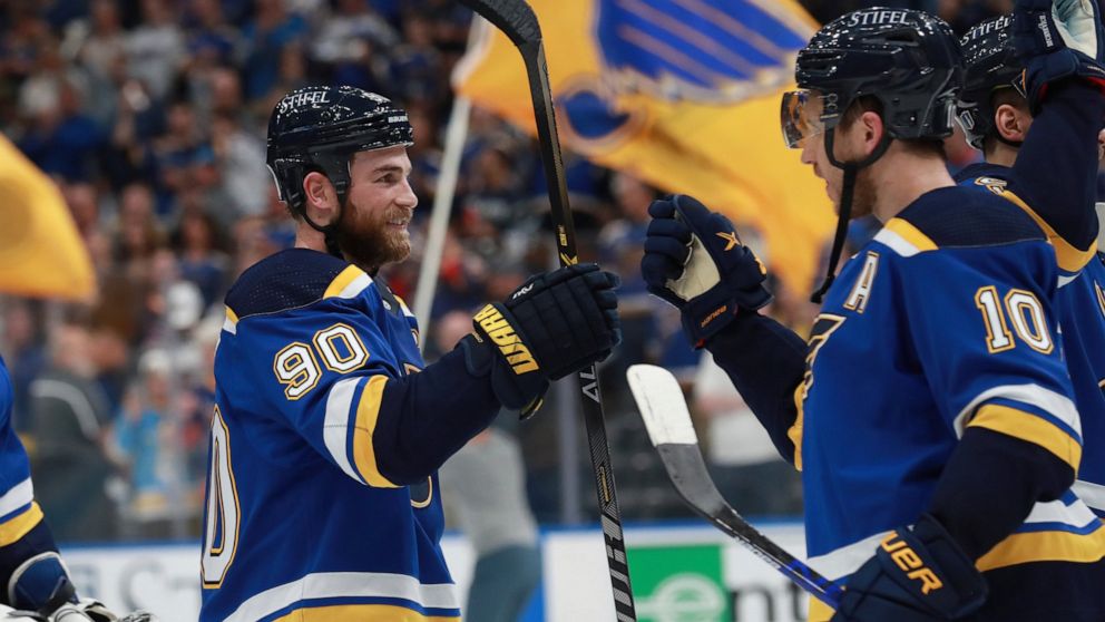 St. Louis Blues' Ryan O'Reilly (90) and Brayden Schenn (10) celebrate after the Blues defeated the Minnesota Wild in Game 6 of an NHL hockey Stanley Cup first-round playoff series Thursday, May 12, 2022, in St. Louis. The Blues advance to the second 