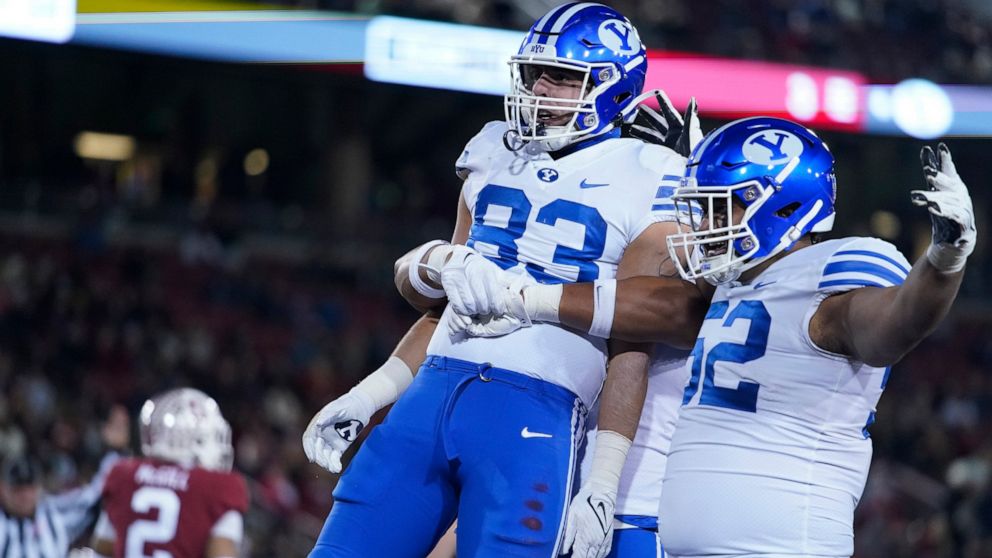 BYU tight end Isaac Rex (83) celebrates with teammates after scoring a 43-yard touchdown against Stanford during the first half of an NCAA college football game in Stanford, Calif., Saturday, Nov. 26, 2022. (AP Photo/Godofredo A. Vásquez)