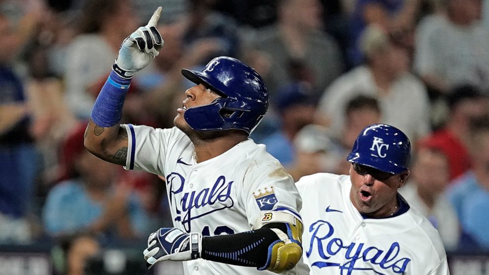 Kansas City Royals' Salvador Perez celebrates with third base coach Vance Wilson after hitting a three-run home run during the seventh inning of a baseball game against the Boston Red Sox Thursday, Aug. 4, 2022, in Kansas City, Mo. (AP Photo/Charlie 