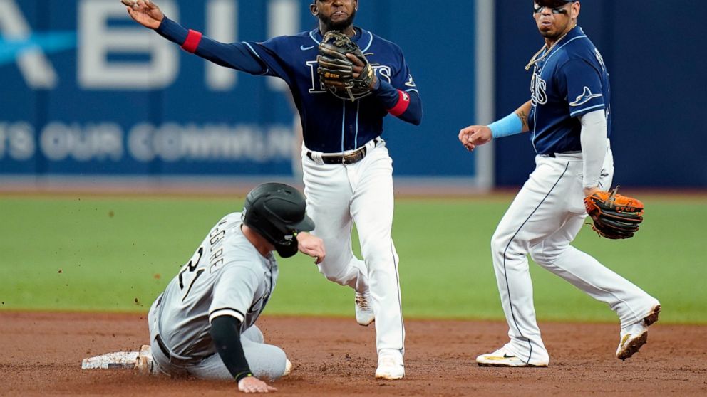 Tampa Bay Rays shortstop Vidal Brujan, center, forces Chicago White Sox's Reese McGuire, left, at second base and relays the throw to first in time to turn a double play on Leury Garcia during the third inning of a baseball game Saturday, June 4, 202