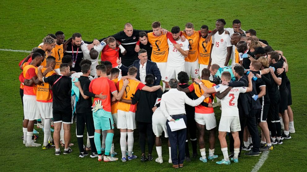 Canada's head coach John Herdman talks with his team after their loss in the World Cup group F soccer match between Belgium and Canada, at the Ahmad Bin Ali Stadium in Doha, Qatar, Wednesday, Nov. 23, 2022. (AP Photo/Ariel Schalit)