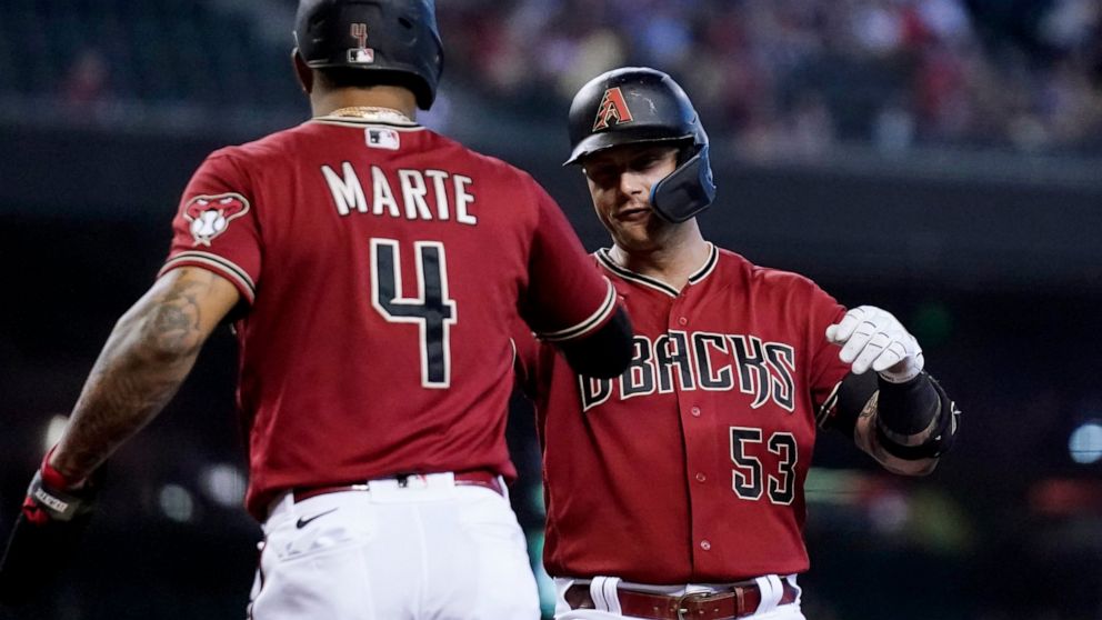 Arizona Diamondbacks' Christian Walker (53) celebrates with Ketel Marte (4) after hitting a two-run home run against the Colorado Rockies during the first inning of a baseball game Sunday, Aug. 7, 2022, in Phoenix. (AP Photo/Ross D. Franklin)