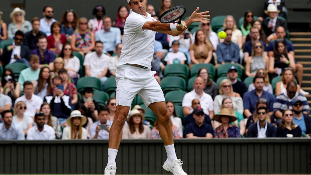 FILE - Switzerland's Roger Federer plays a return to Britain's Cameron Norrie during the men's singles third round match on day six of the Wimbledon Tennis Championships in London, Saturday July 3, 2021. Federer announced Thursday, Sept.15, 2022 he i