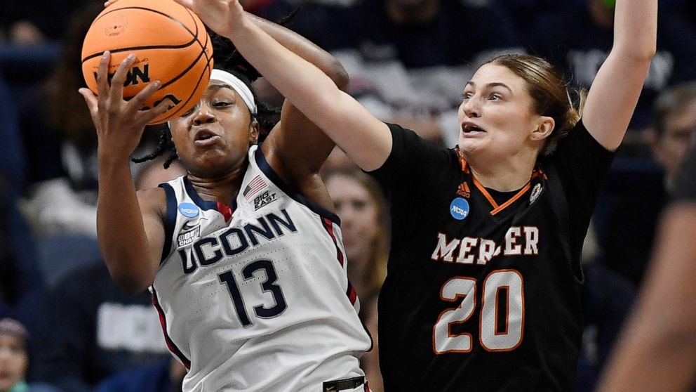Connecticut's Christyn Williams (13) and Mercer's Sierra Votaw (20) reach for a rebound during the first half of a first-round women's college basketball game in the NCAA tournament, Saturday, March 19, 2022, in Storrs, Conn. (AP Photo/Jessica Hill)