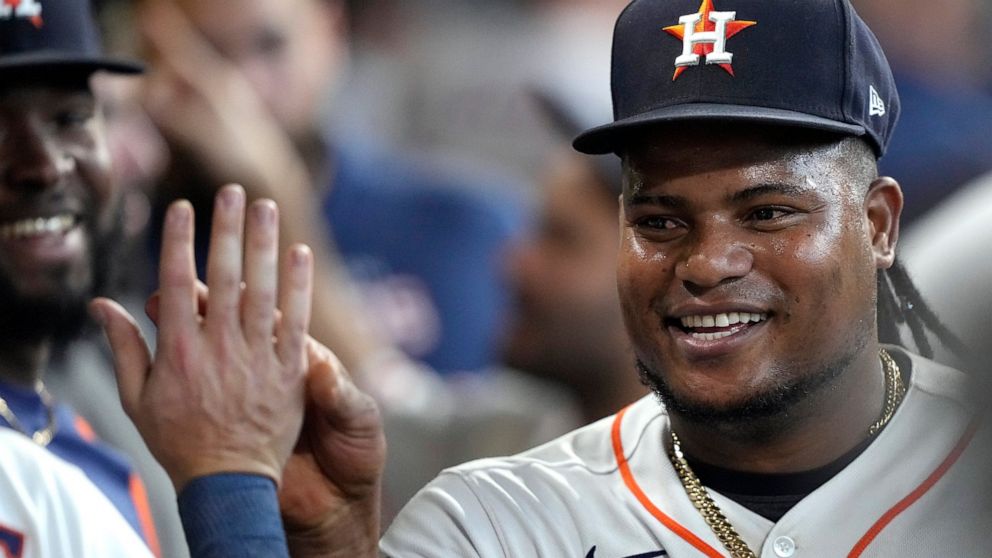 Houston Astros starting pitcher Framber Valdez is congratulated in the dugout after pitching the fifth inning of a baseball game against the Philadelphia Phillies Wednesday, Oct. 5, 2022, in Houston. (AP Photo/David J. Phillip)