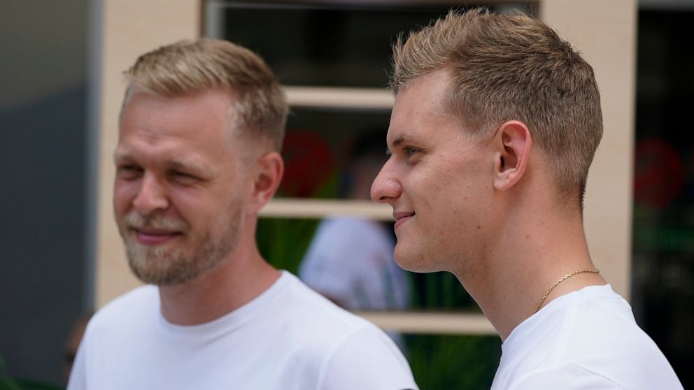 Haas driver Kevin Magnussen, left, of Denmark, stands with Haas driver Mick Schumacher, of Germany, during an interview ahead of the Formula One Miami Grand Prix auto race at Miami International Autodrome, Thursday, May 5, 2022, in Miami Gardens, Fla