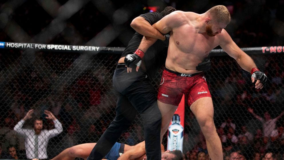 Jan Blachowicz, right, reacts after knocking out Luke Rockhold during the second round of their light heavyweight mixed martial arts bout at UFC 239, Saturday, July 6, 2019, in Las Vegas. (AP Photo/Eric Jamison)