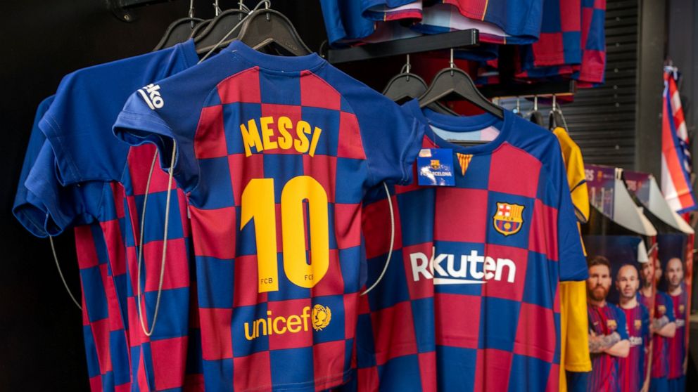 Lionel Messi shirts are displayed in a souvenir store in downtown Madrid, Spain, Friday, Aug. 6, 2021. Messi is leaving after leading Barcelona into its most glorious years. He helped the club win 35 titles, including the Champions League four times,