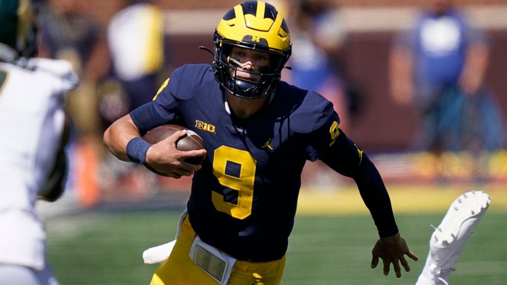 FILE - Michigan quarterback J.J. McCarthy rushes during the second half of an NCAA college football game against Colorado State, on Saturday, Sept. 3, 2022, in Ann Arbor, Mich. No. 4 Michigan is giving McCarthy a shot to start, and he seems to be set