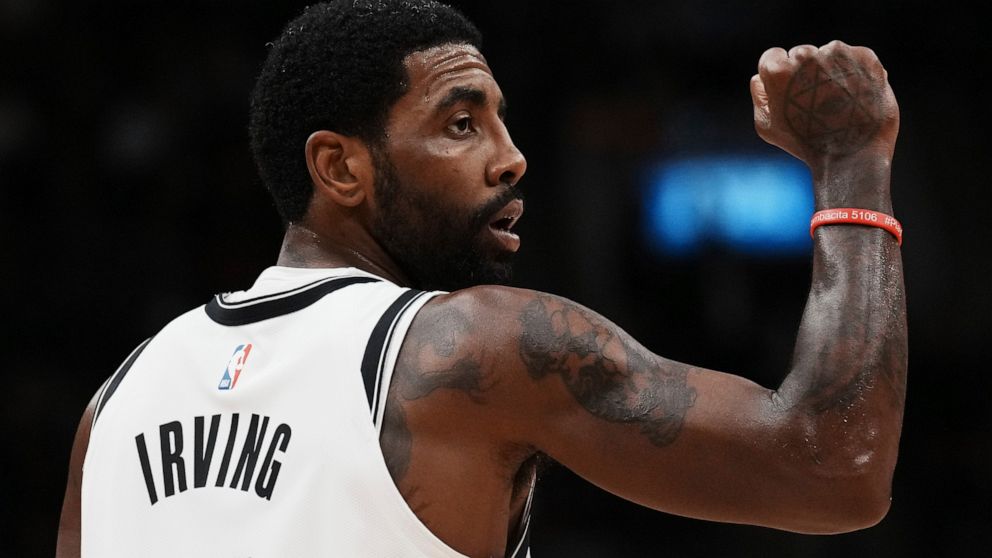 Brooklyn Nets guard Kyrie Irving celebrates a basket against the Toronto Raptors during the second half of an NBA basketball game Wednesday, Nov. 23, 2022, in Toronto. (Chris Young/The Canadian Press via AP)