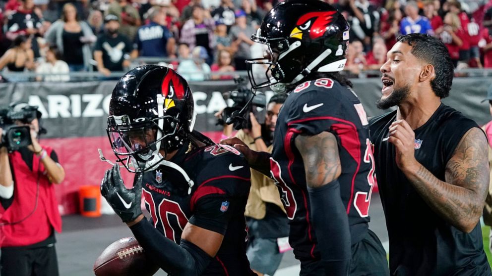 Arizona Cardinals cornerback Marco Wilson (20) celebrates his pick six touchdown interception with cornerback Antonio Hamilton and injured running back James Conner, right, during the first half of an NFL football game against the New Orleans Saints,
