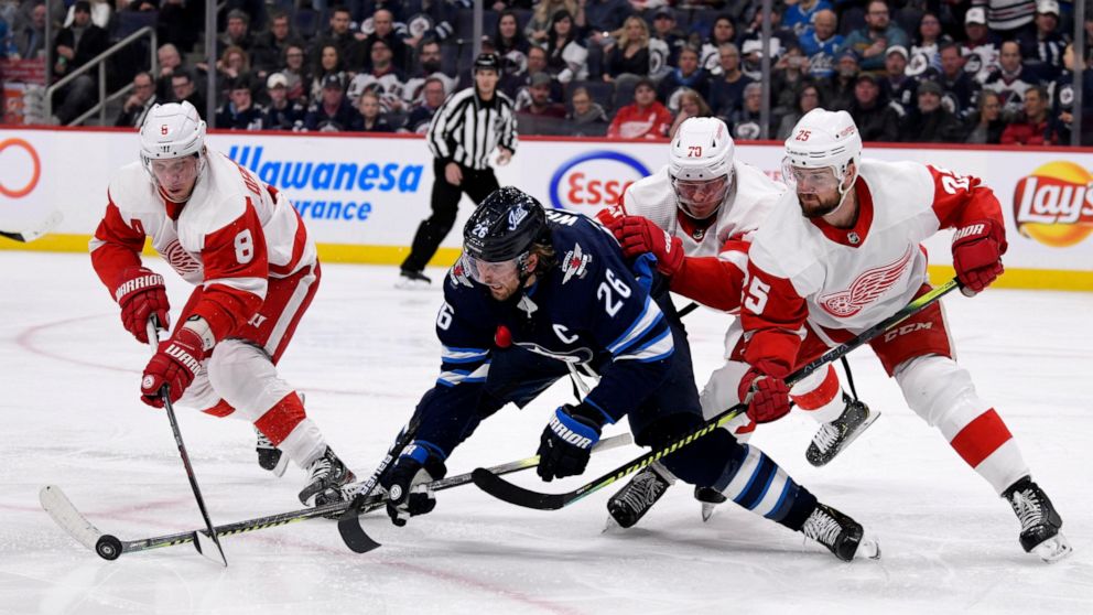Winnipeg Jets' Blake Wheeler (26) fights for possession of the puck against Detroit Red Wings' Justin Abdelkader (8), Christoffer Ehn (70) and Mike Green (25) during the second period of an NHL hockey game, Tuesday, Dec. 10, 2019, in Winnipeg, Manito