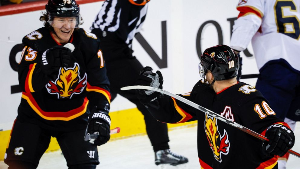 Calgary Flames forward Jonathan Huberdeau, right, celebrates his goal against the Florida Panthers with Tyler Toffoli during the first period of an NHL hockey game Tuesday, Nov. 29, 2022, in Calgary, Alberta. (Jeff McIntosh/The Canadian Press via AP)