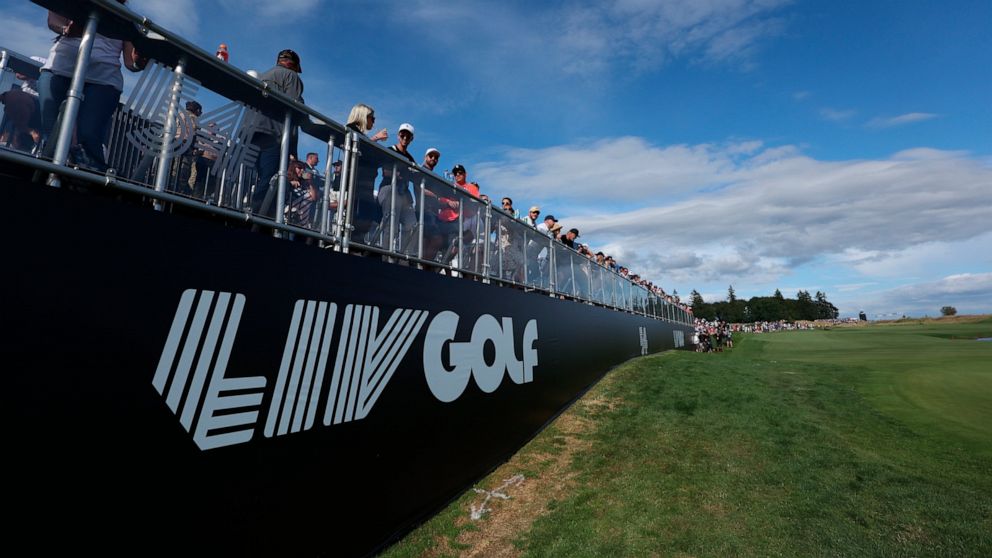 Fans await the final grouping at the 18th hole during the third round of the Portland Invitational LIV Golf tournament in North Plains, Ore., Saturday, July 2, 2022. (AP Photo/Steve Dipaola)