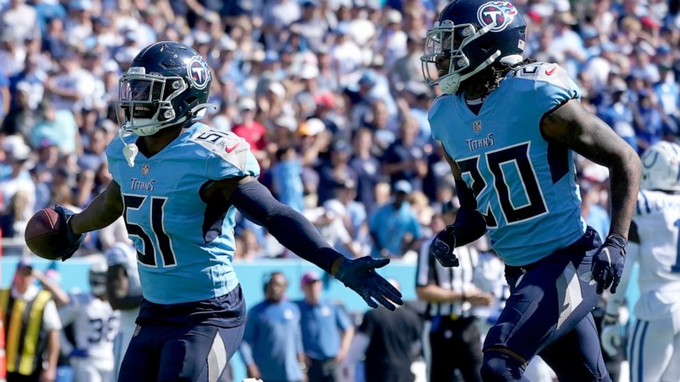 Tennessee Titans linebacker David Long Jr. (51) celebrates after intercepting a pass as teammate Lonnie Johnson (20) watches during the first half of an NFL football game against the Indianapolis Colts Sunday, Oct. 23, 2022, in Nashville, Tenn. (AP P