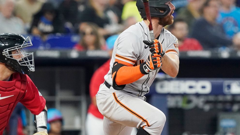 San Francisco Giants second baseman Donovan Walton (37) watches his hit go deep into left field during the fourth inning of a baseball game against the Miami Marlins, Saturday, June 4, 2022, in Miami. The Giants scored three runs on the play. (AP Pho