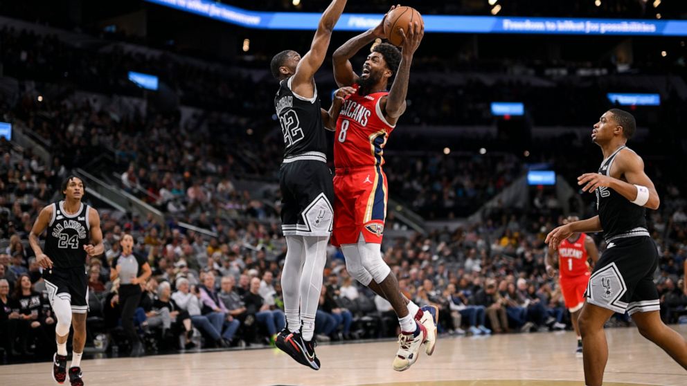 New Orleans Pelicans' Naji Marshall (8) shoots against San Antonio Spurs' Malaki Branham during the second half of an NBA basketball game, Friday, Dec. 2, 2022, in San Antonio. (AP Photo/Darren Abate)